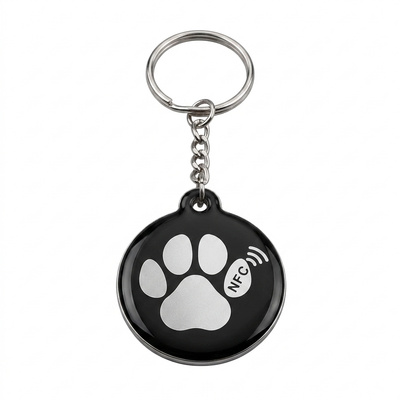 Round black NFC pet ID tag with a white paw print and NFC symbol, on a split ring