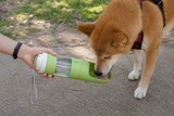 Green 2-in-1 pet travel bottle shown in use
