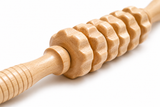 Close-up of the ridged wooden maderoterapia roller and its grooved handle
