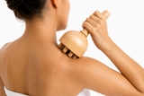 Wood therapy roller tool being used during an at-home body sculpting session