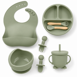 All pieces of the silicone baby feeding set laid out in sage green