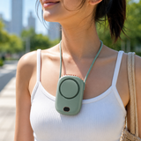 Woman wearing the green bladeless fan as a hands-free neck fan outdoors