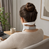 Person wearing the white neck support brace at a desk, viewed from behind