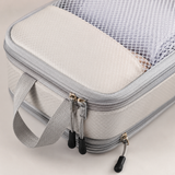 Close-up of a packing cube dual compression zippers, mesh panel and carry handle