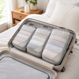 Packing cubes organized inside an open suitcase on a bed