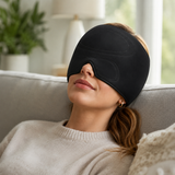 Person relaxing on a couch wearing the black cooling comfort cap over their eyes