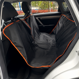 Waterproof black dog car back-seat hammock with orange trim installed in a car