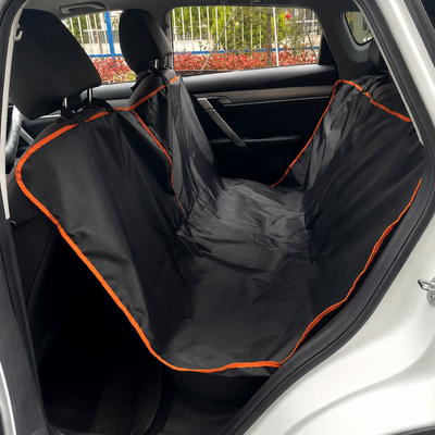 Waterproof black dog car back-seat hammock with orange trim installed in a car