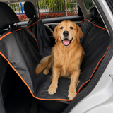 Happy golden retriever sitting on the black and orange dog car hammock