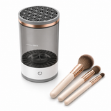 Electric makeup brush cleaner shown with clean makeup brushes on white