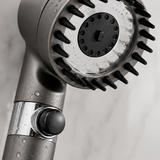 Macro close-up of the shower head stainless spray face, silicone massage rim and stop button