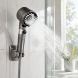 High-pressure shower head spraying a strong jet in a bright modern bathroom