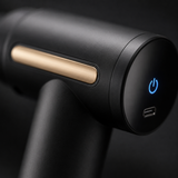 Close-up of the massage gun glowing LED power screen and brushed gold accent
