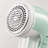 Close-up of the fabric shaver perforated stainless mesh head and white collar