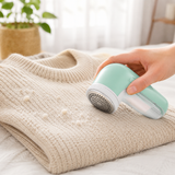 Fabric shaver removing pills from a knit sweater in a bright home
