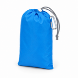 Beach blanket packed into its compact blue drawstring pouch with a carabiner