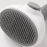 Close-up of the slicker brush fine wire bristles and one-click button