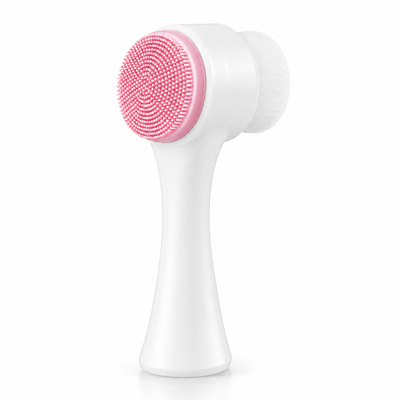 Pink double-sided silicone facial cleansing brush on a white studio background
