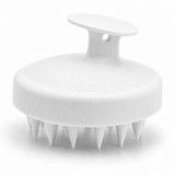 White silicone scalp massage brush on white background
