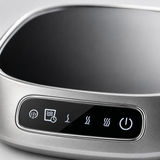 Close-up of the smart mug warmer's glossy black glass top and silver touch-control panel