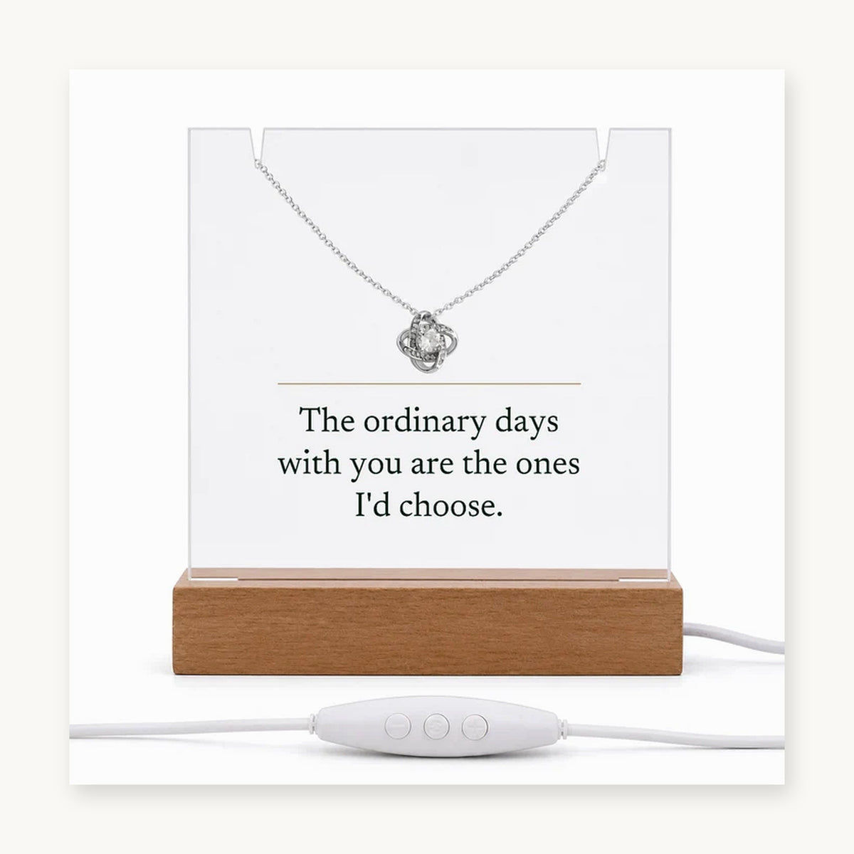 The Keepsake Set on its wooden LED base with the Love Knot necklace, the acrylic printed: The ordinary days with you are the ones I'd choose