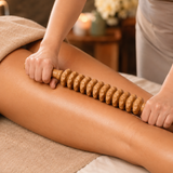 Therapist using the wooden roller tool during a body sculpting spa massage